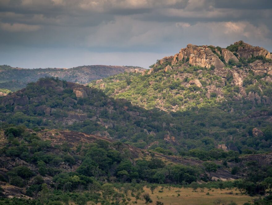 Green and Rocky Mountains Under Cloudy Sky — illustrative stock photograph