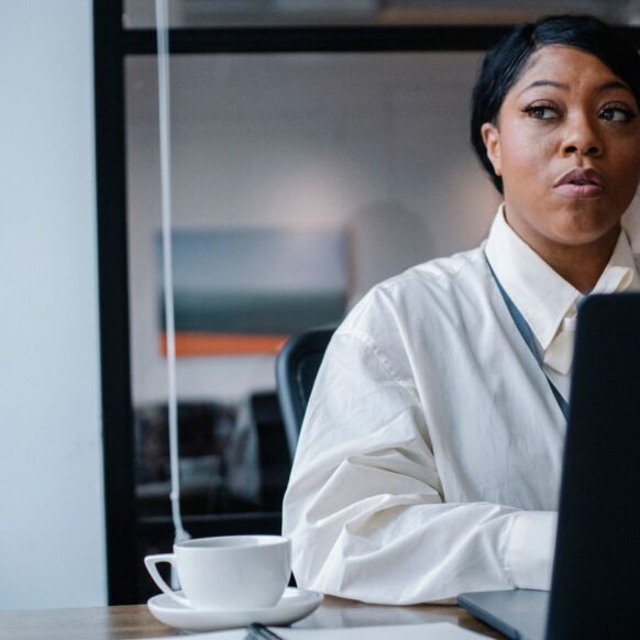 Thoughtful black businesswoman working on project in office — illustrative stock photograph